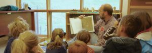 Photo of a man reading a storybook