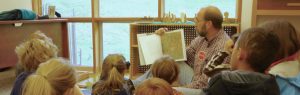 Photo of a man reading a storybook